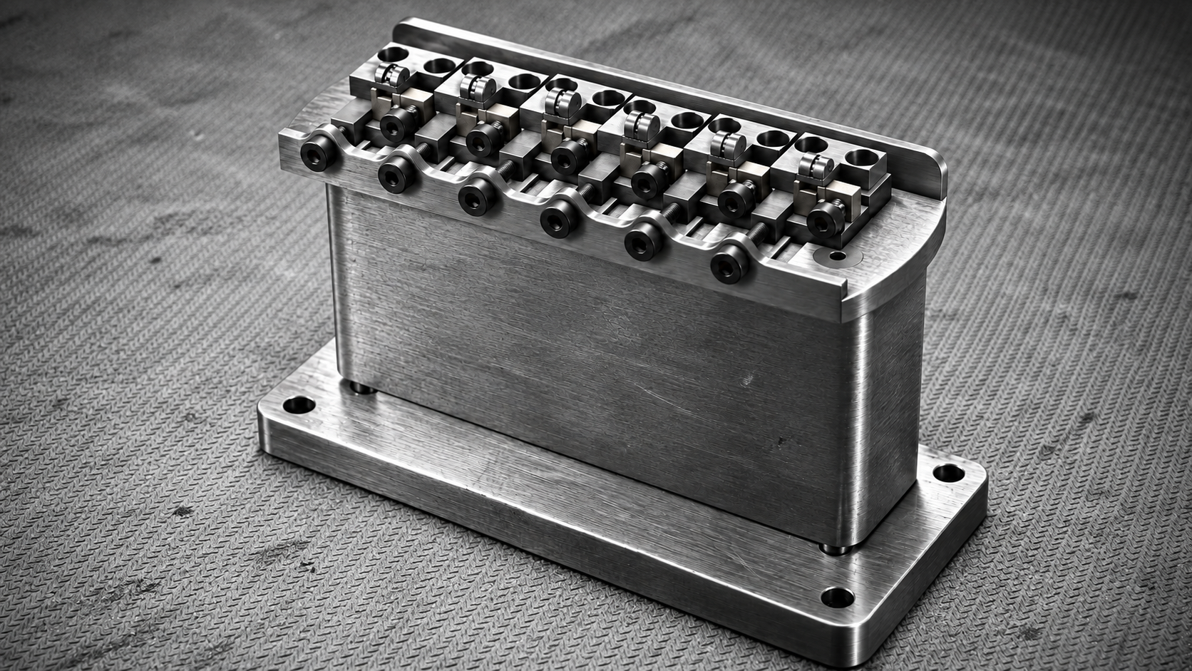 Current Artifact bridge with six individual saddles above the sustain block and rear base plate